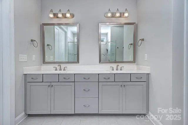 a bathroom with a sink vanity and mirror