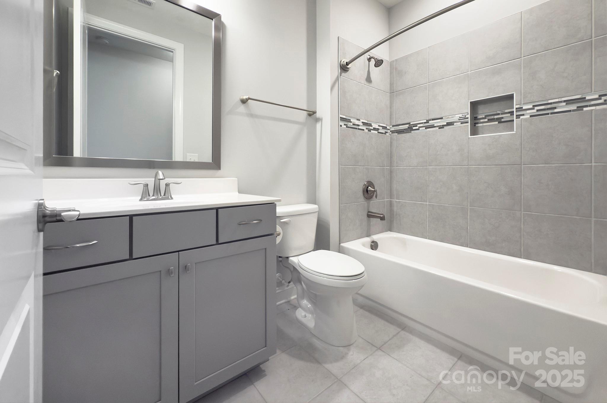 5527 Cheerful Lane Charlotte, NC 28215 - Photo 25 of 46 a bathroom with a sink a toilet and shower