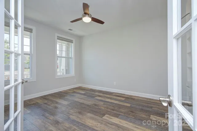 wooden floor in an empty room with a window