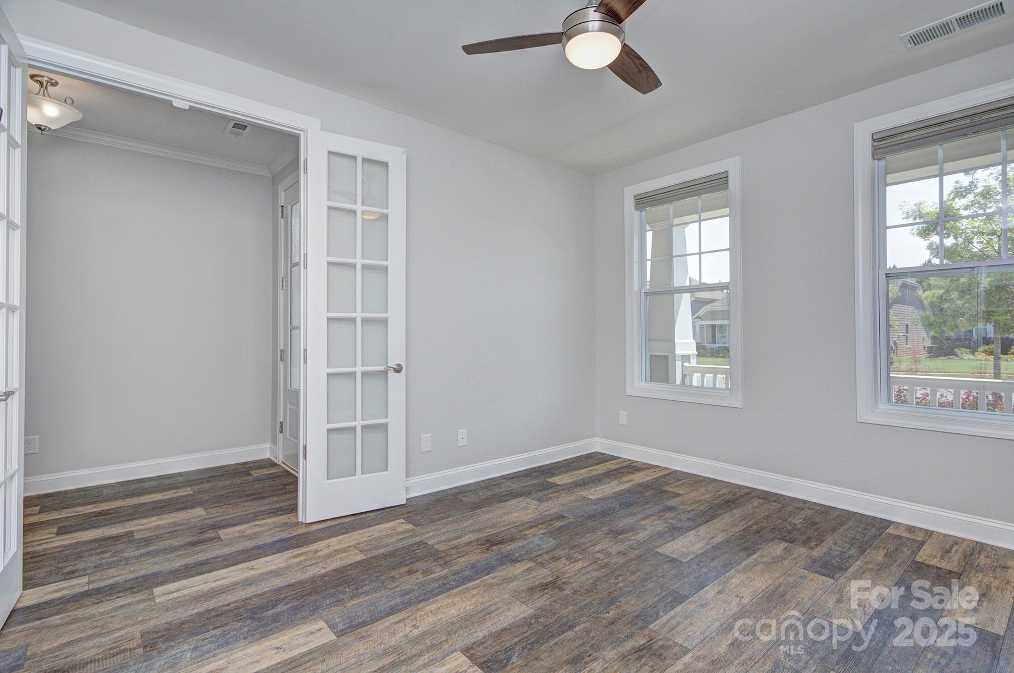 5527 Cheerful Lane Charlotte, NC 28215 - Photo 27 of 46 an empty room with wooden floor cabinet and windows