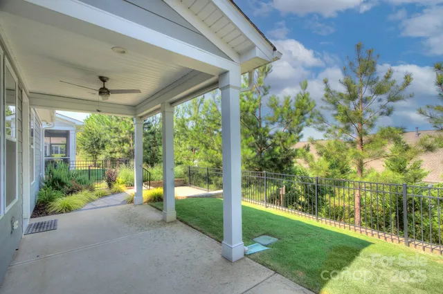 a view of a porch with couches and wooden floor