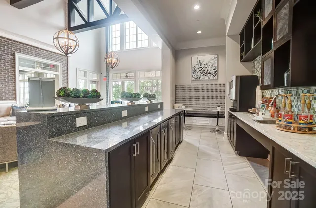 a kitchen with stainless steel appliances granite countertop a sink counter space cabinets and a large window