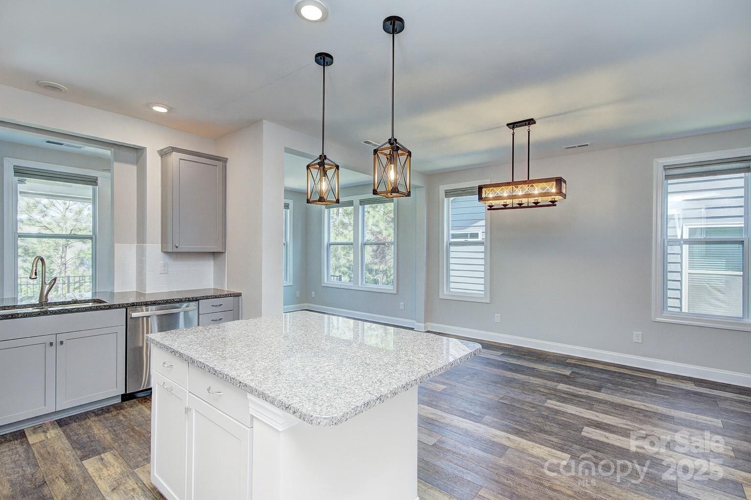 5527 Cheerful Lane Charlotte, NC 28215 - Photo 5 of 46 a kitchen with stainless steel appliances granite countertop stove a sink and a wooden floor