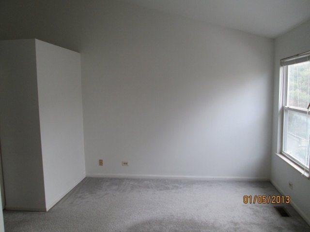1074 Stillwater Road Elgin, IL 60120 - Photo 9 of 11 an empty room with windows