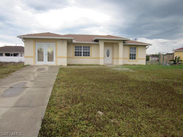 4002 5th Street Southwest Lehigh Acres, FL 33976 - Photo 1 of 2 a view of a house with a garden