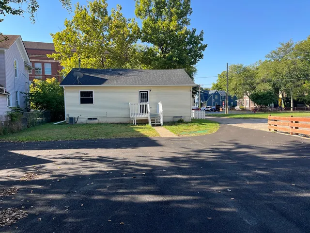 a view of a house with a swimming pool and yard with green space