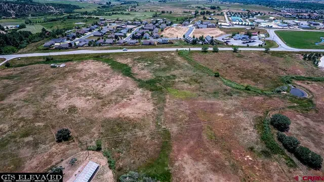 an aerial view of residential house and green space