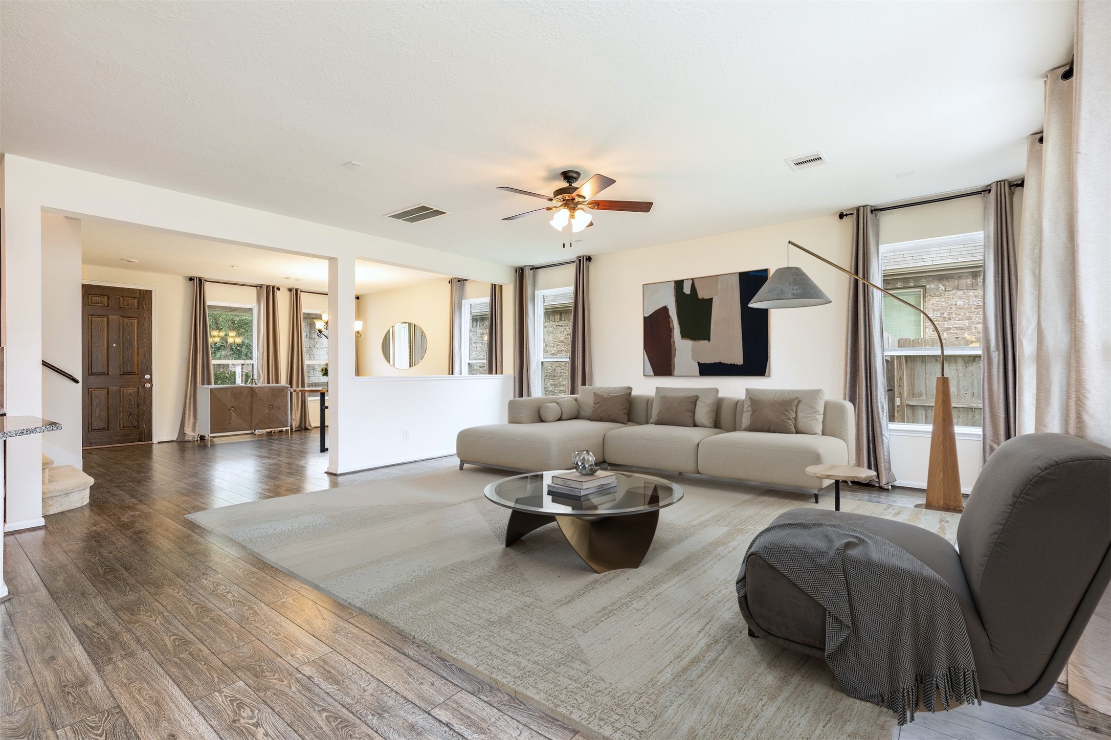 a living room with furniture and wooden floor