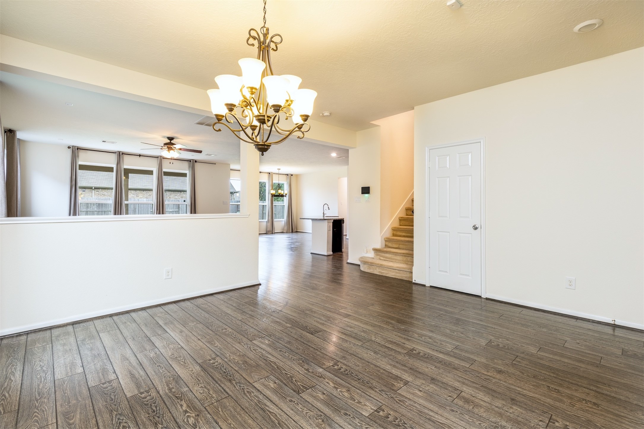 15623 Hanover Breeze Lane Houston, TX 77044 - Photo 5 of 46 a view of a livingroom with wooden floor and chandelier