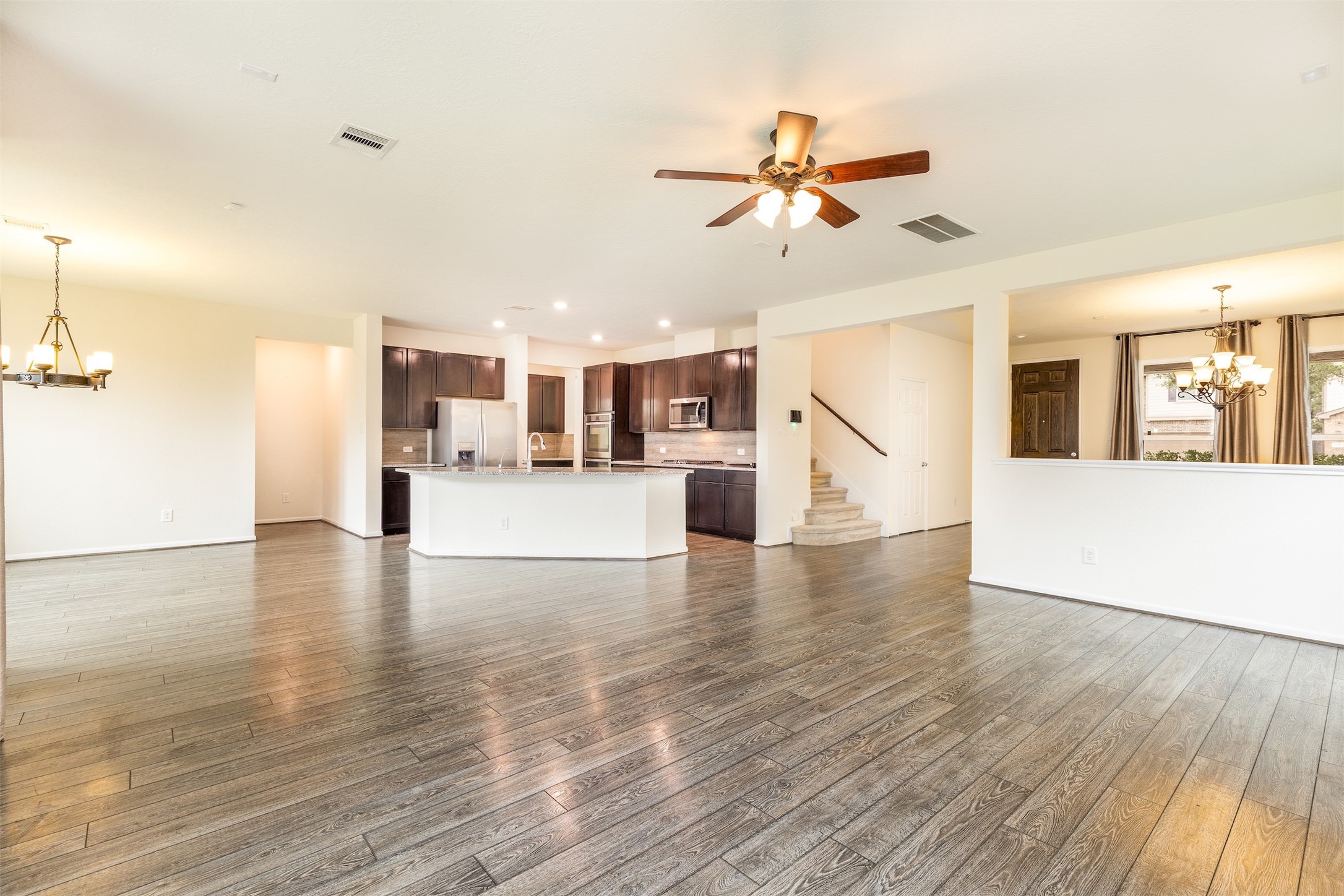 15623 Hanover Breeze Lane Houston, TX 77044 - Photo 7 of 46 a view of a kitchen with wooden floor and a kitchen