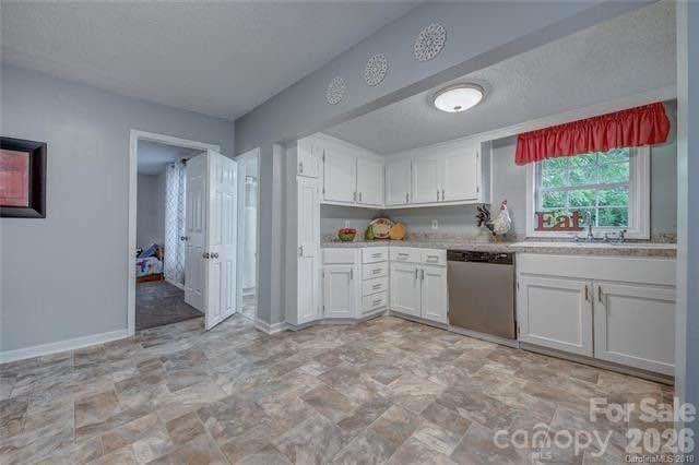 116 7th Street Cramerton, NC 28032 - Photo 5 of 9 a kitchen with white cabinets and white appliances