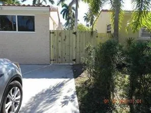 a view of a house with a backyard and trees
