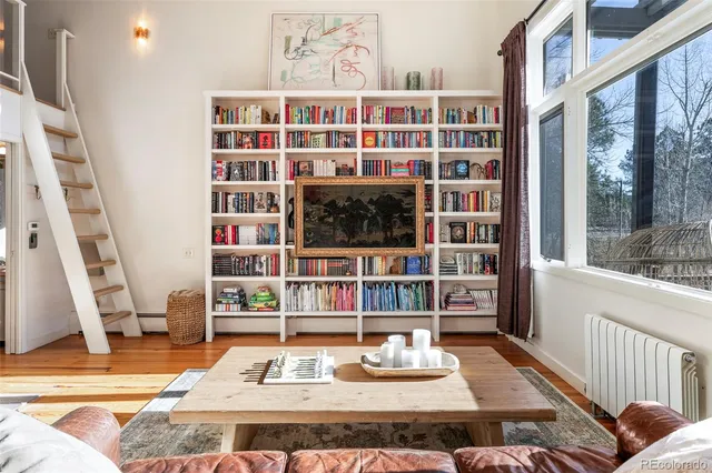 a view of living room with furniture and book shelf