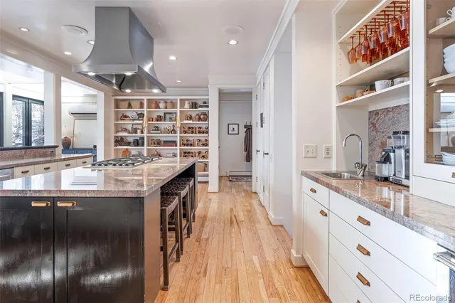 a kitchen with granite countertop a sink and cabinets