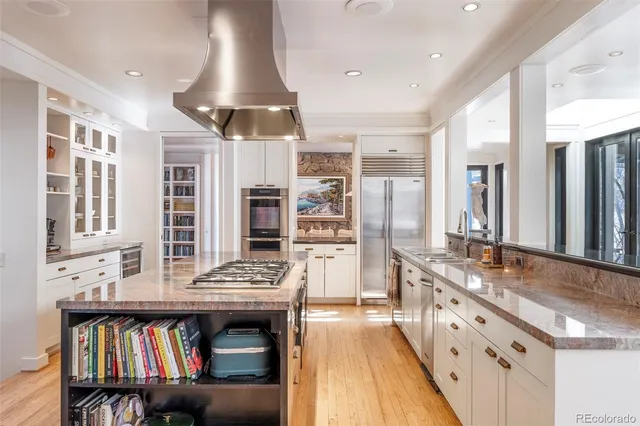 a kitchen with stainless steel appliances granite countertop a stove and cabinets