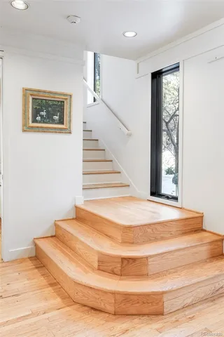 a view of a room with wooden floor and window