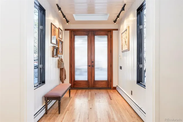 a view of a room with furniture and wooden floor