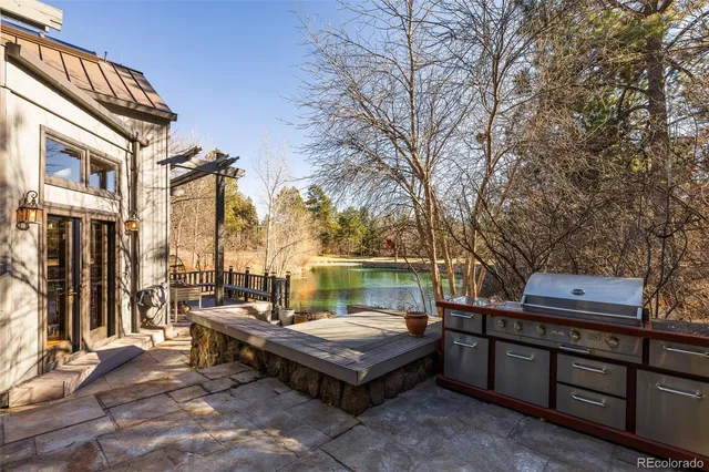 a backyard of a house with barbeque oven and outdoor seating
