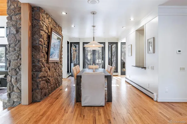 a view of a living room and kitchen with furniture wooden floor and windows