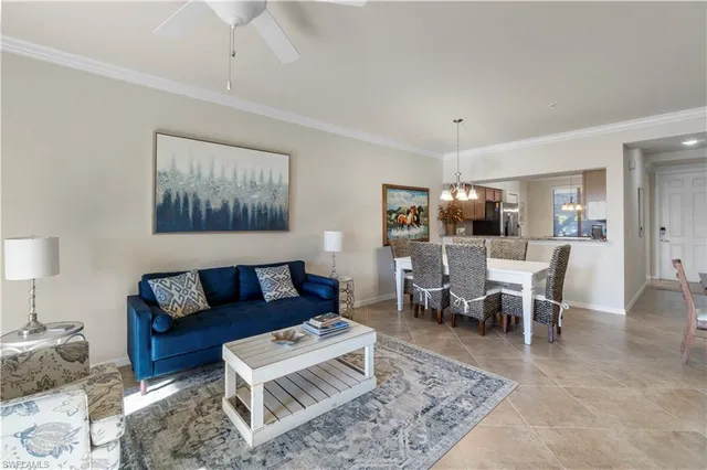 a living room with furniture a rug and a table