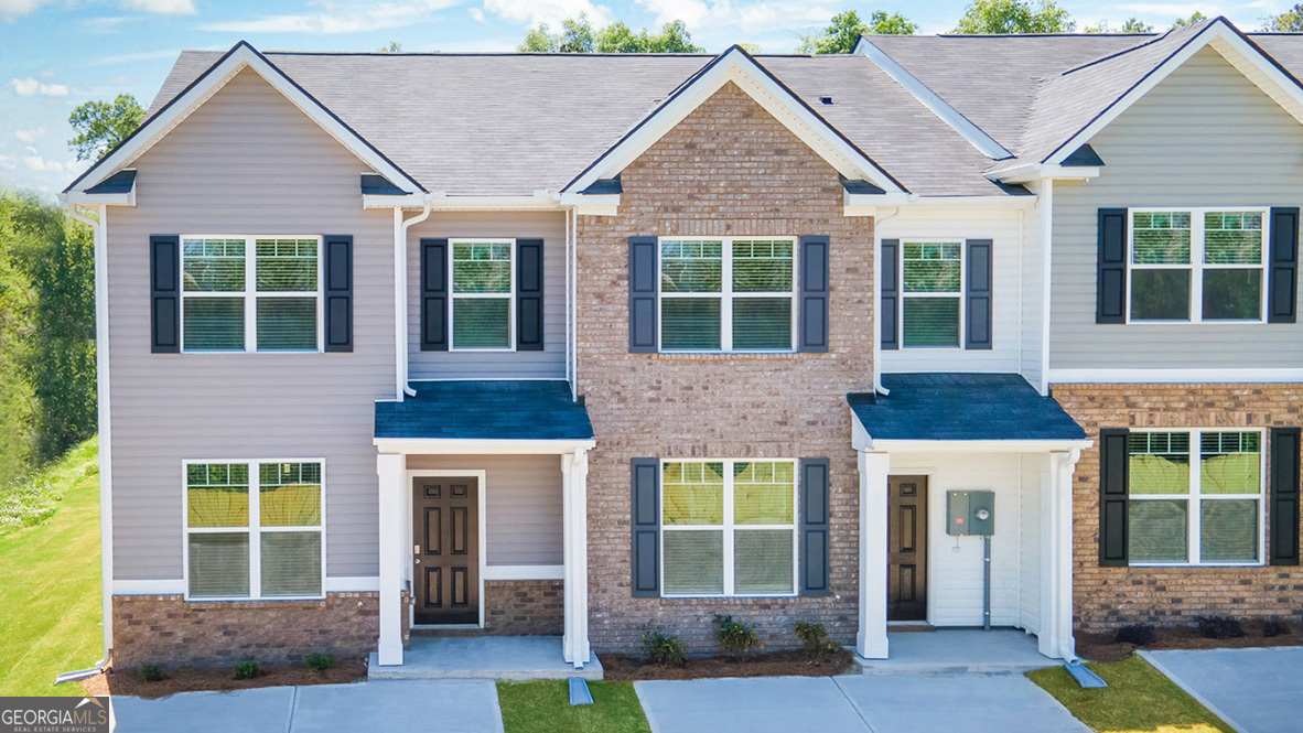 2634 Axel Ridge, Unit 64 Decatur, GA 30034 - Photo 1 of 1 a front view of a house with a yard and potted plants