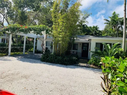 a view of house with outdoor space and garden