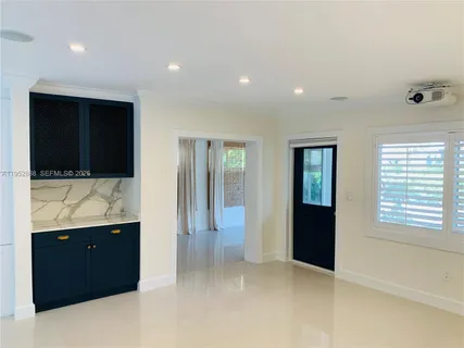 a view of hallway with bathroom and mirror