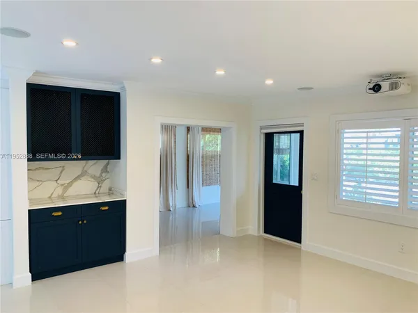 a view of hallway with bathroom and mirror