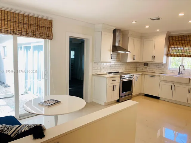 a view of walk in closet with clothes and window