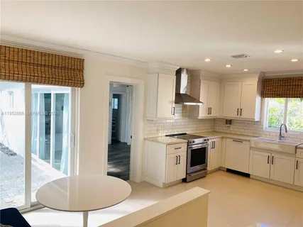 a kitchen with stainless steel appliances granite countertop a stove top oven a sink and a granite counter tops