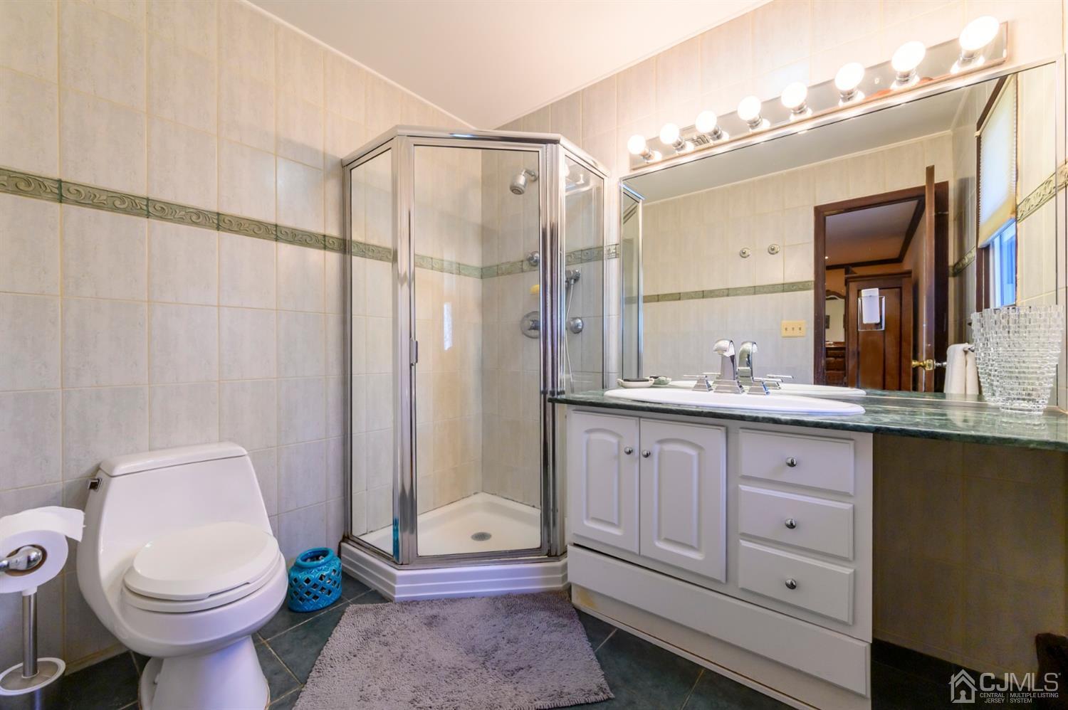 56 Valley View Road Warren, NJ 07059 - Photo 22 of 40 a bathroom with a granite countertop sink toilet and shower