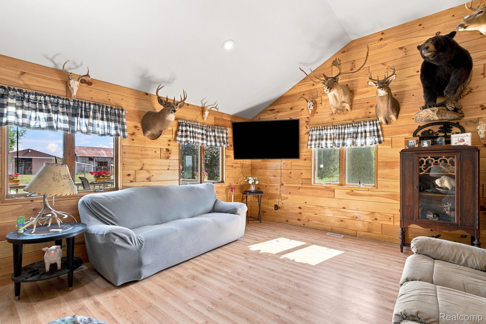 4201 Galbraith Line Road Croswell, MI 48422 - Photo 4 of 39 Vaulted ceiling room featuring light wood-finish flooring and extensive wood plank wall finishes