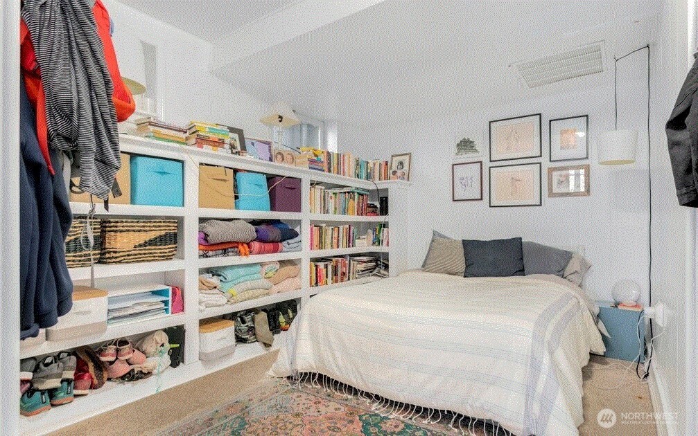 1745 12th Avenue South, Unit 1 4 Seattle, WA 98144 - Photo 11 of 39 a bedroom with a bed and a book shelf