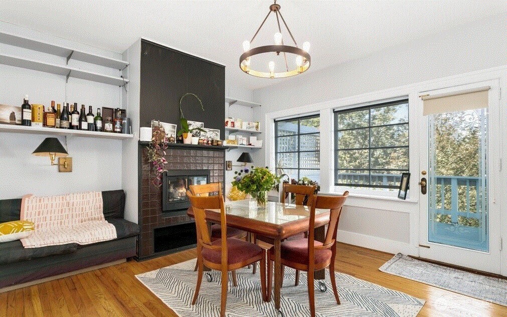 1745 12th Avenue South, Unit 1 4 Seattle, WA 98144 - Photo 19 of 39 a dining room with furniture a chandelier and wooden floor