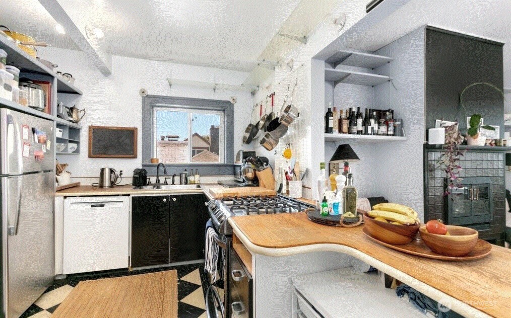 1745 12th Avenue South, Unit 1 4 Seattle, WA 98144 - Photo 23 of 39 a kitchen with a sink stove and cabinets