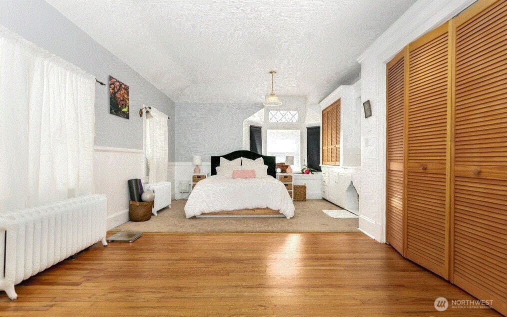 1745 12th Avenue South, Unit 1 4 Seattle, WA 98144 - Photo 24 of 39 a bedroom with a bed and wooden floor
