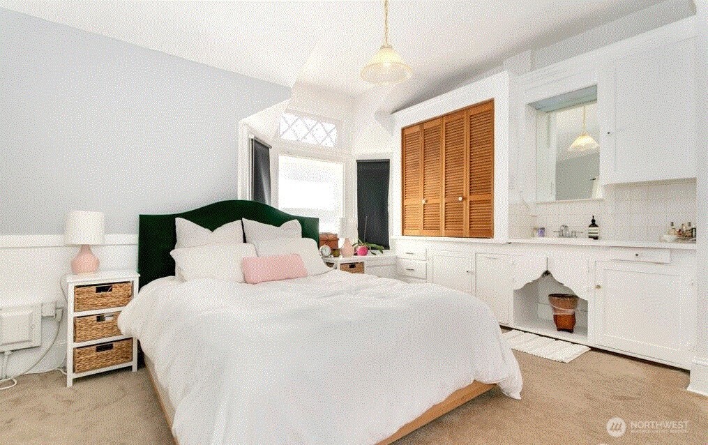1745 12th Avenue South, Unit 1 4 Seattle, WA 98144 - Photo 25 of 39 a bedroom with a bed and a chandelier