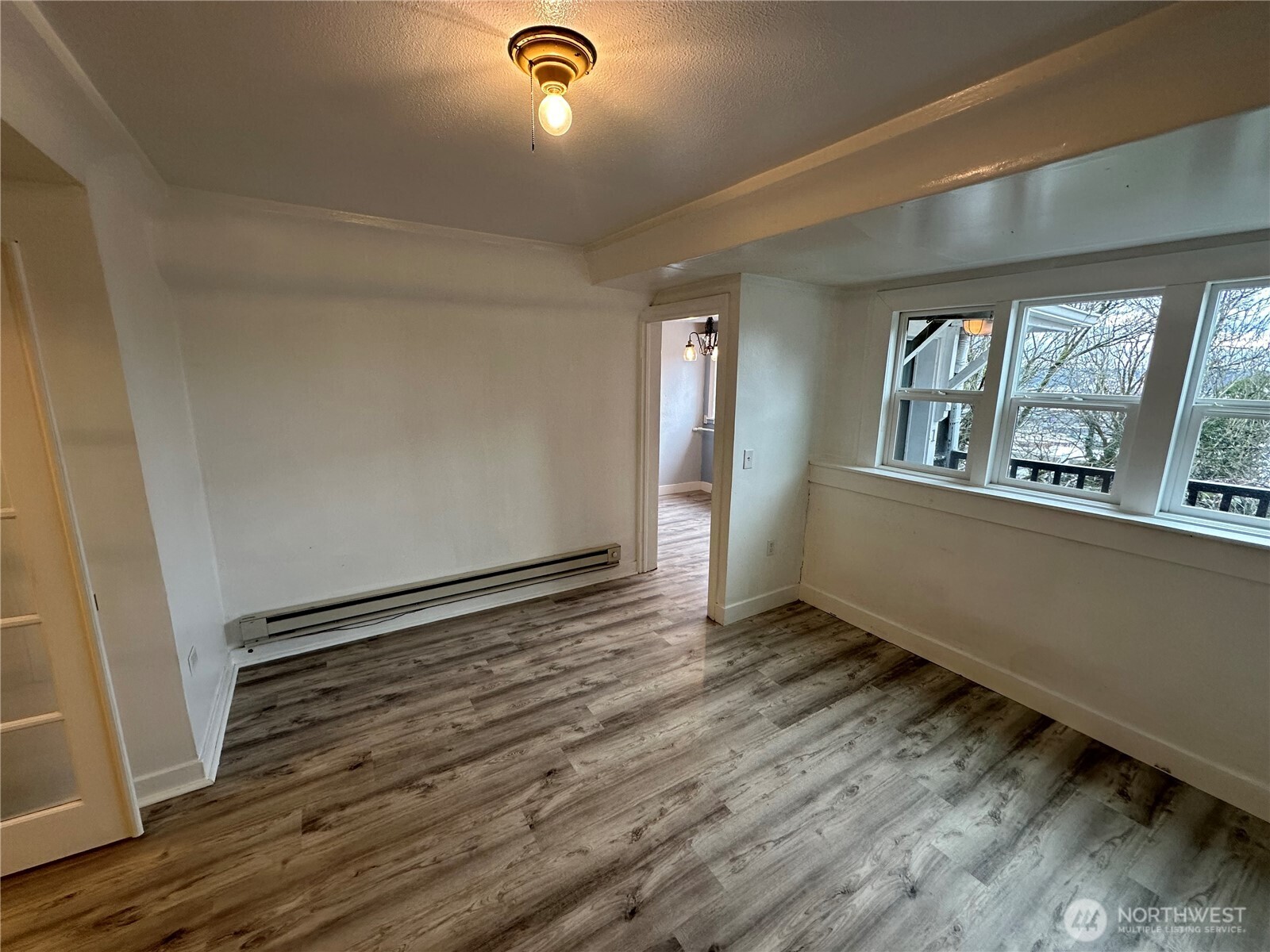 1745 12th Avenue South, Unit 1 4 Seattle, WA 98144 - Photo 36 of 39 an empty room with wooden floor and windows