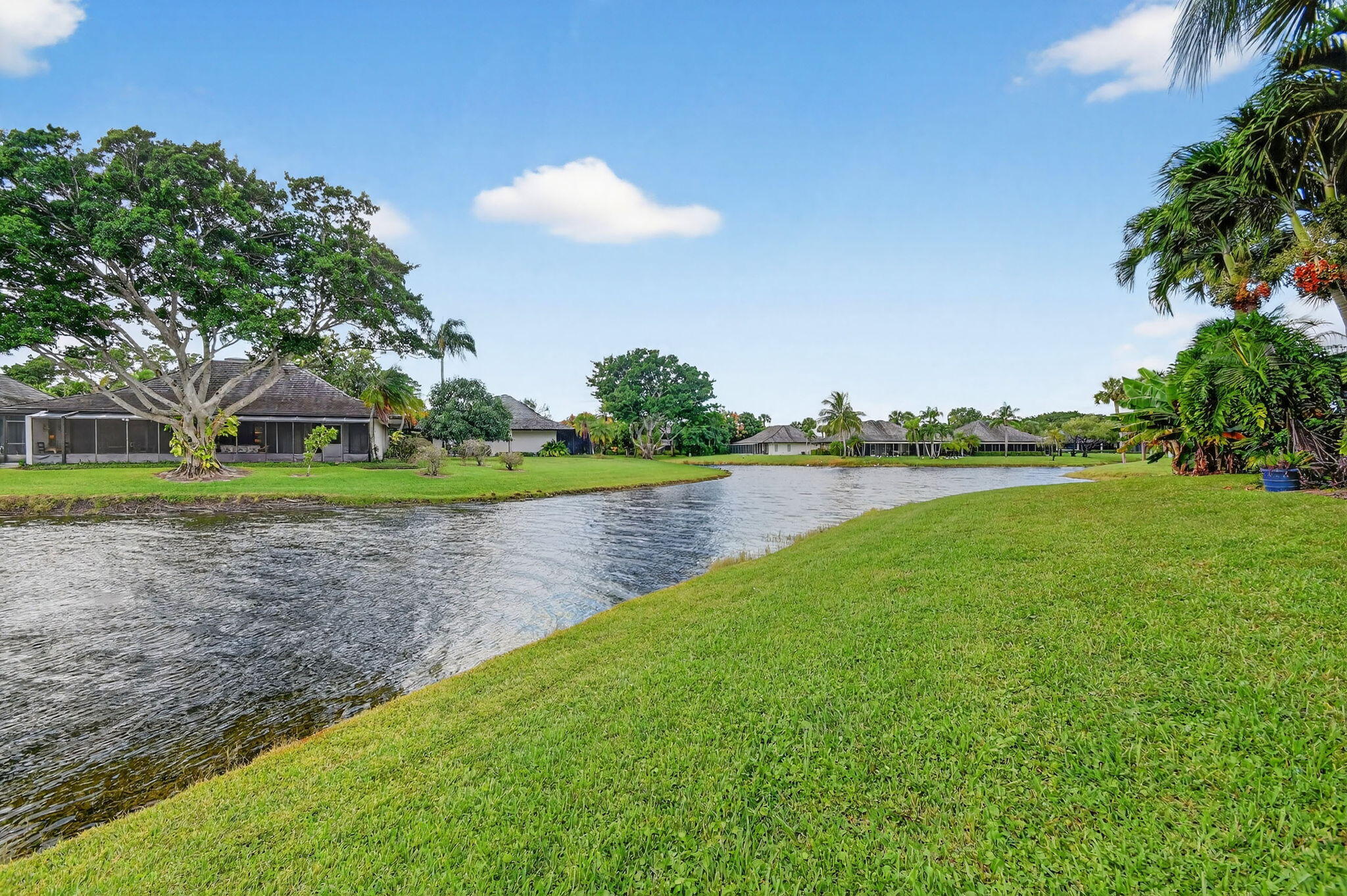 11854 Rene Lacoste Place Wellington, FL 33414 - Photo 39 of 45 a view of a lake with houses in the background