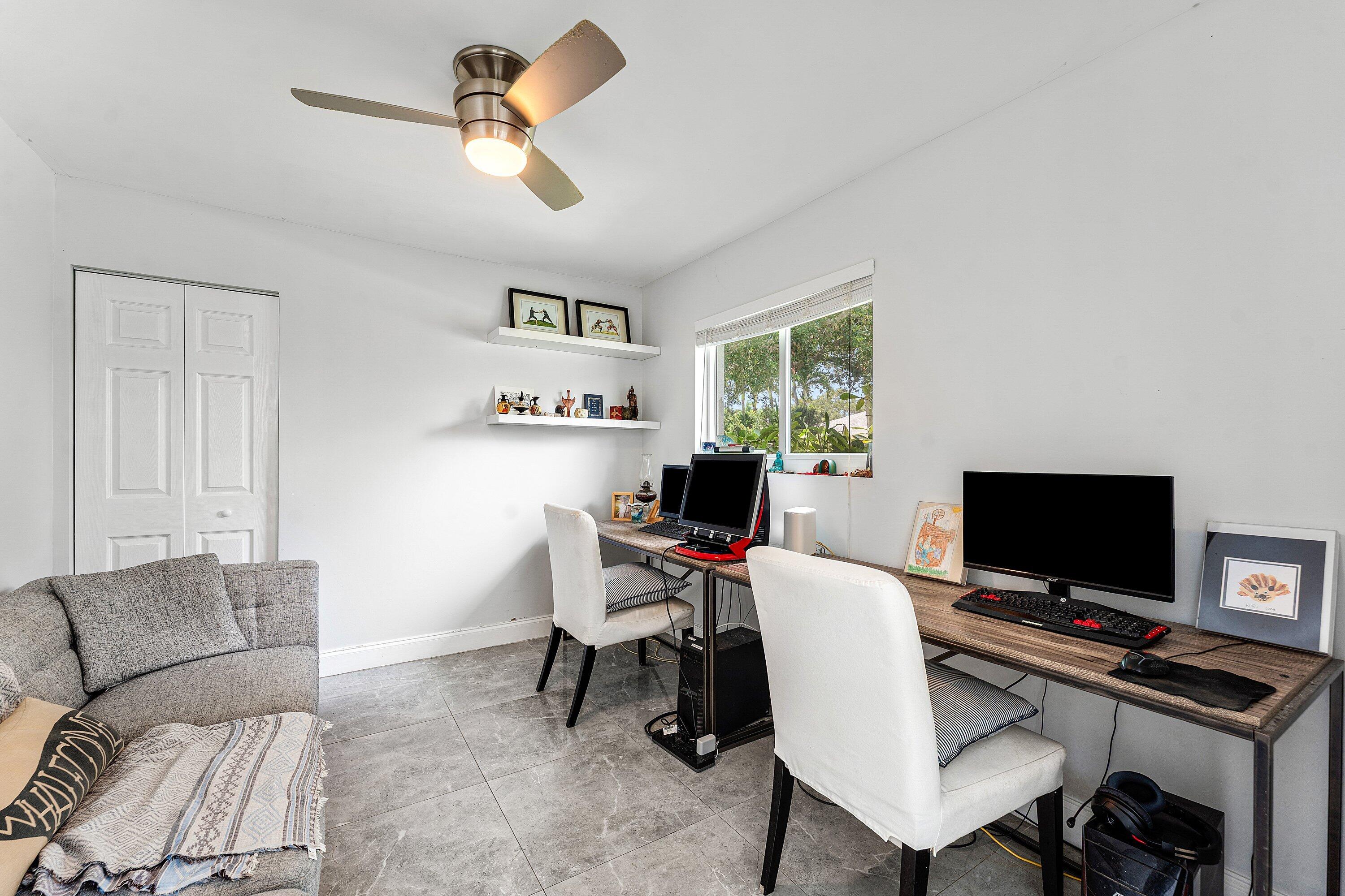 581 Northwest 13th Drive Boca Raton, FL 33486 - Photo 29 of 39 a view of a livingroom with furniture and a flat screen tv