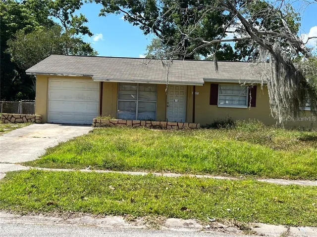 a front view of house with yard and trees