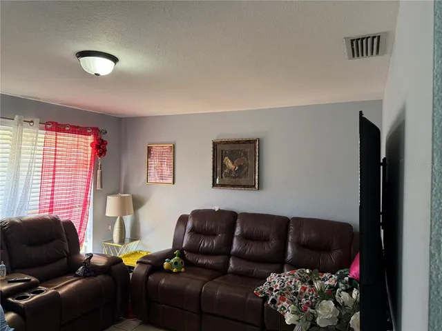 a living room with furniture couch and a window
