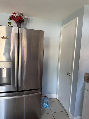 a view of a hallway with a refrigerator