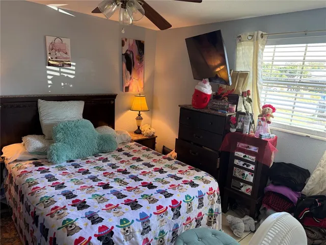 a bedroom with a bed and dresser with mirror