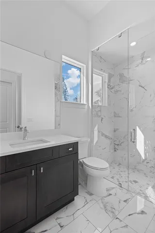 a bathroom with a double vanity sink toilet and a mirror