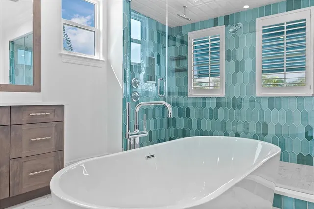 a bath tub sitting in a bathroom next to a window