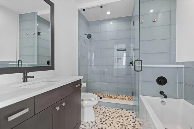 a bathroom with a sink toilet a shower and a mirror