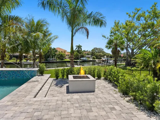 a house view with a garden space and swimming pool in back