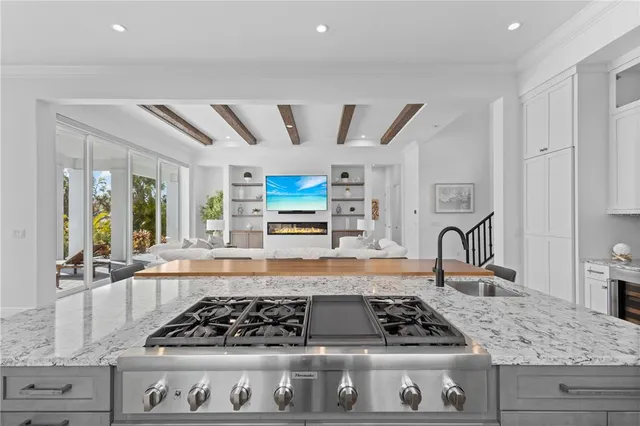 a kitchen with stainless steel appliances granite countertop a stove and cabinets