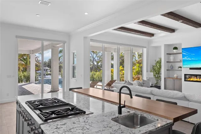 a kitchen with sink stove and dining area